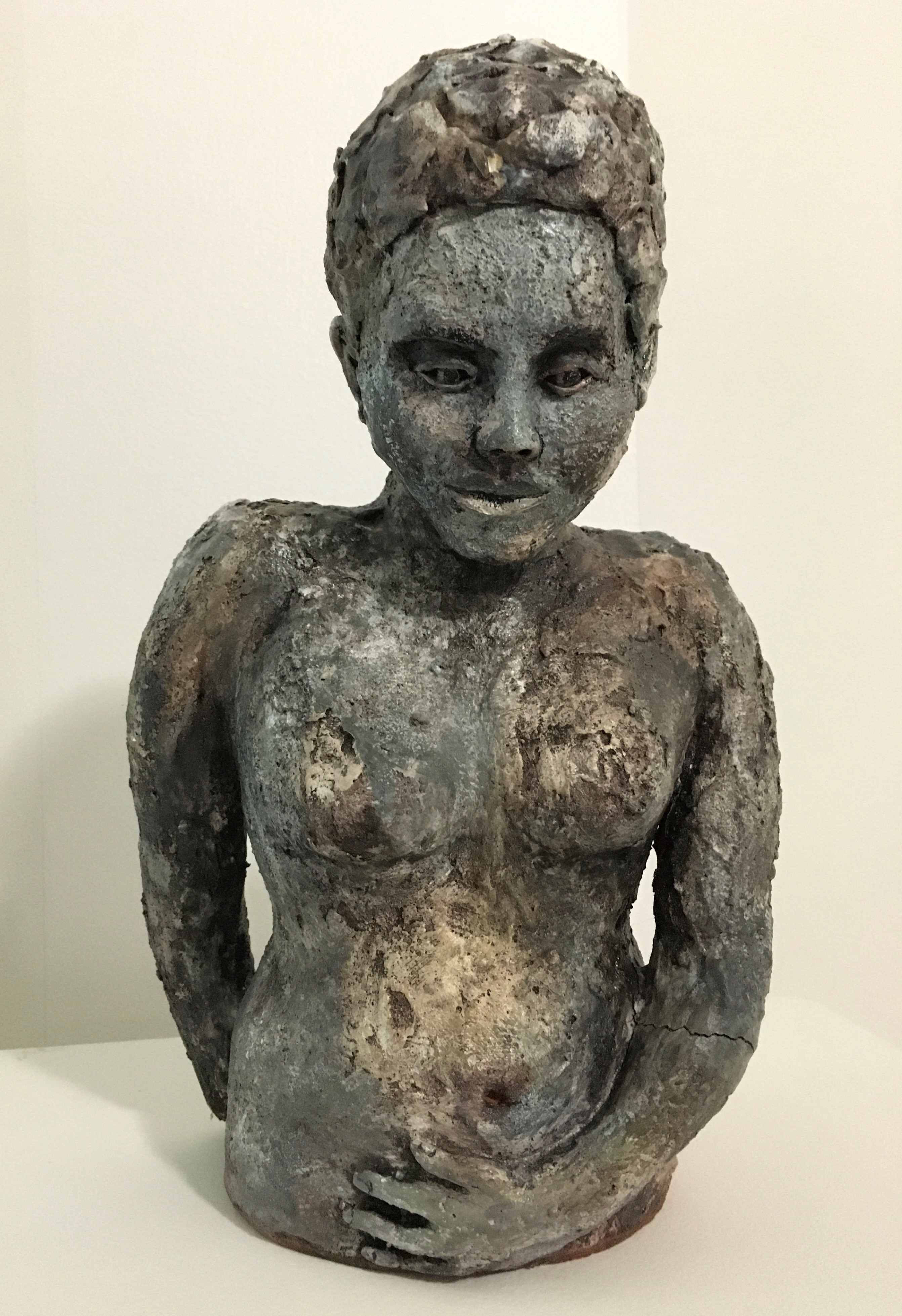 a sculptural figure of a woman