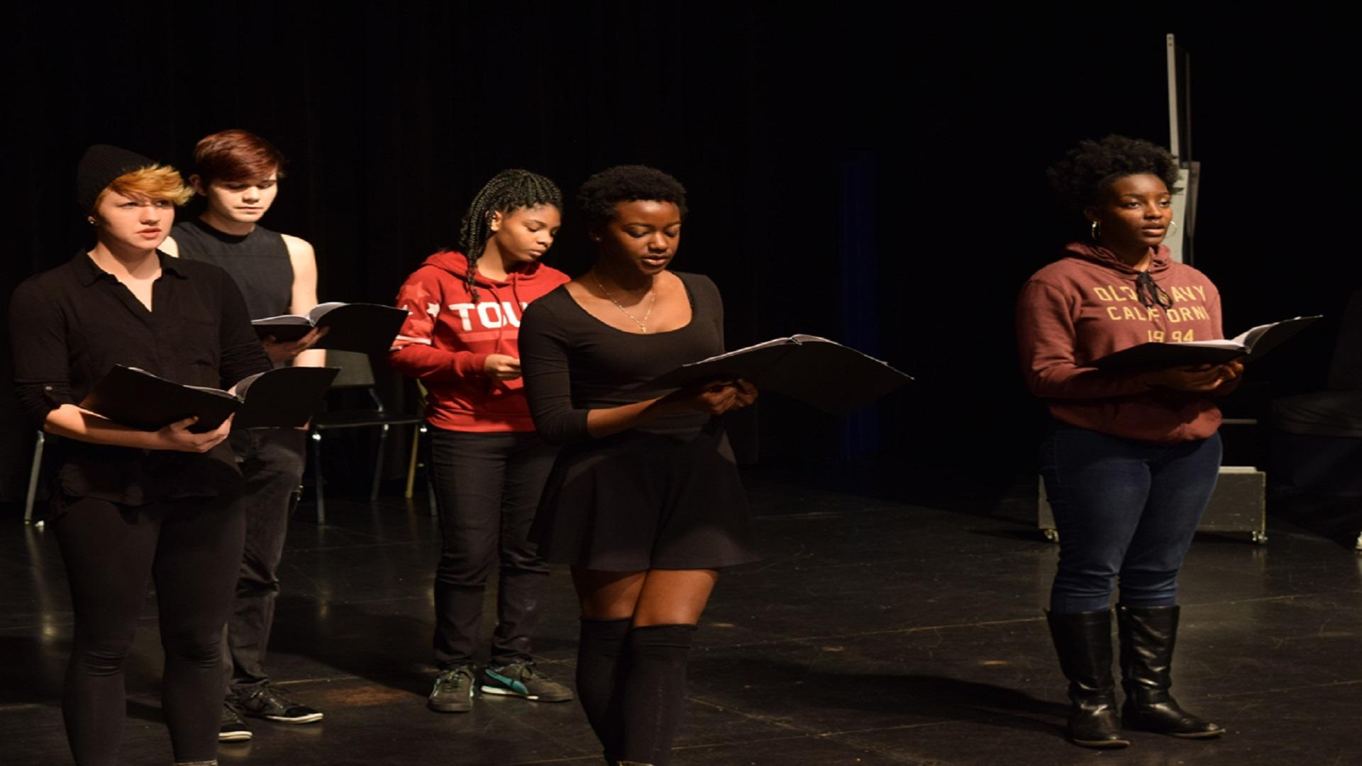 Students on stage singing