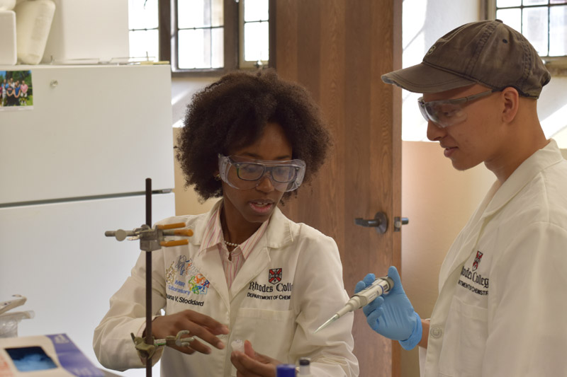 a professor and student with pipettes