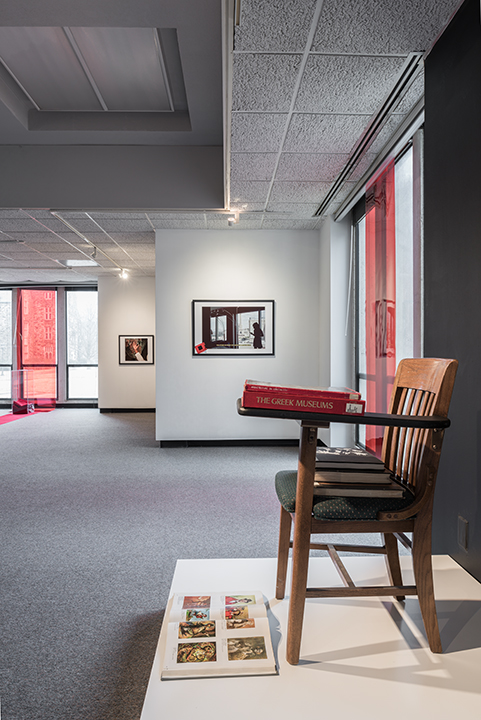 Installation with chair, book and photographs.