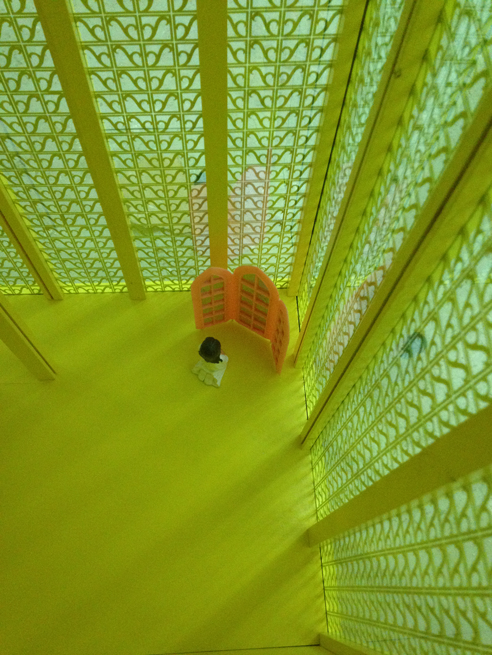 interior view of a yellow skyscraper with a small figure