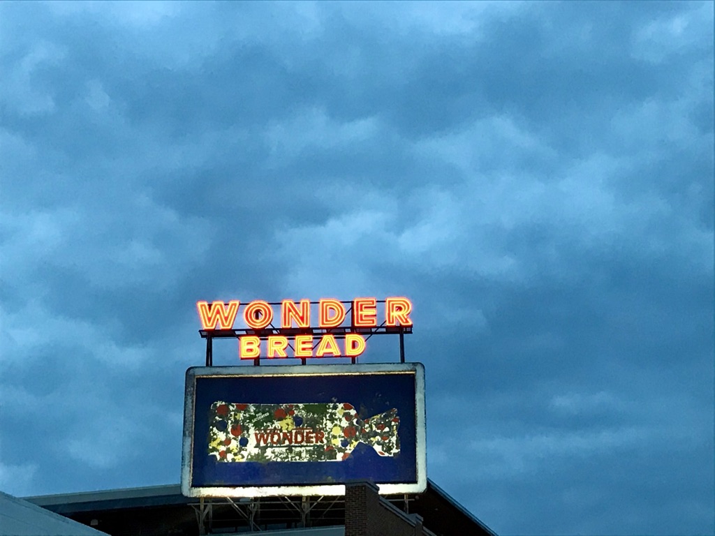 an older billboard for Wonder Bread against a blue sky
