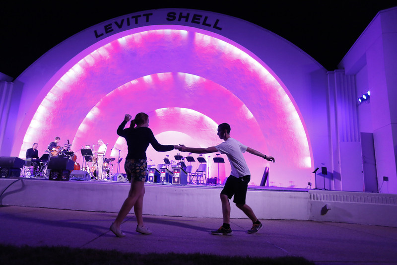 students dance in front of a stage