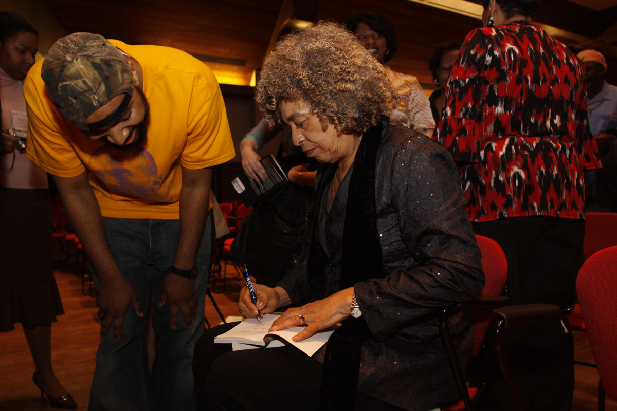 Angela Davis autographs a book