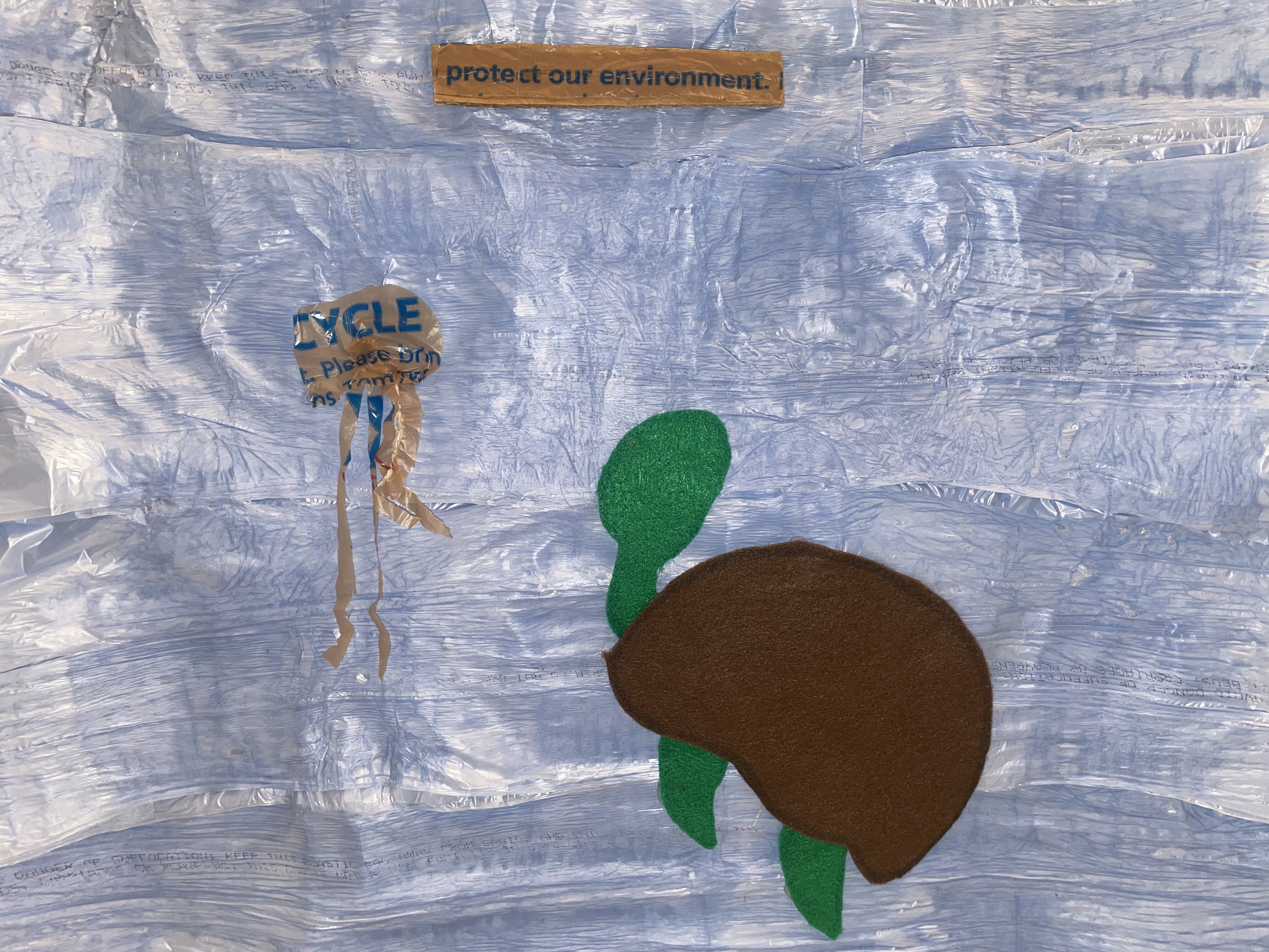 an image of water and a turtle made in plastic bags and felt