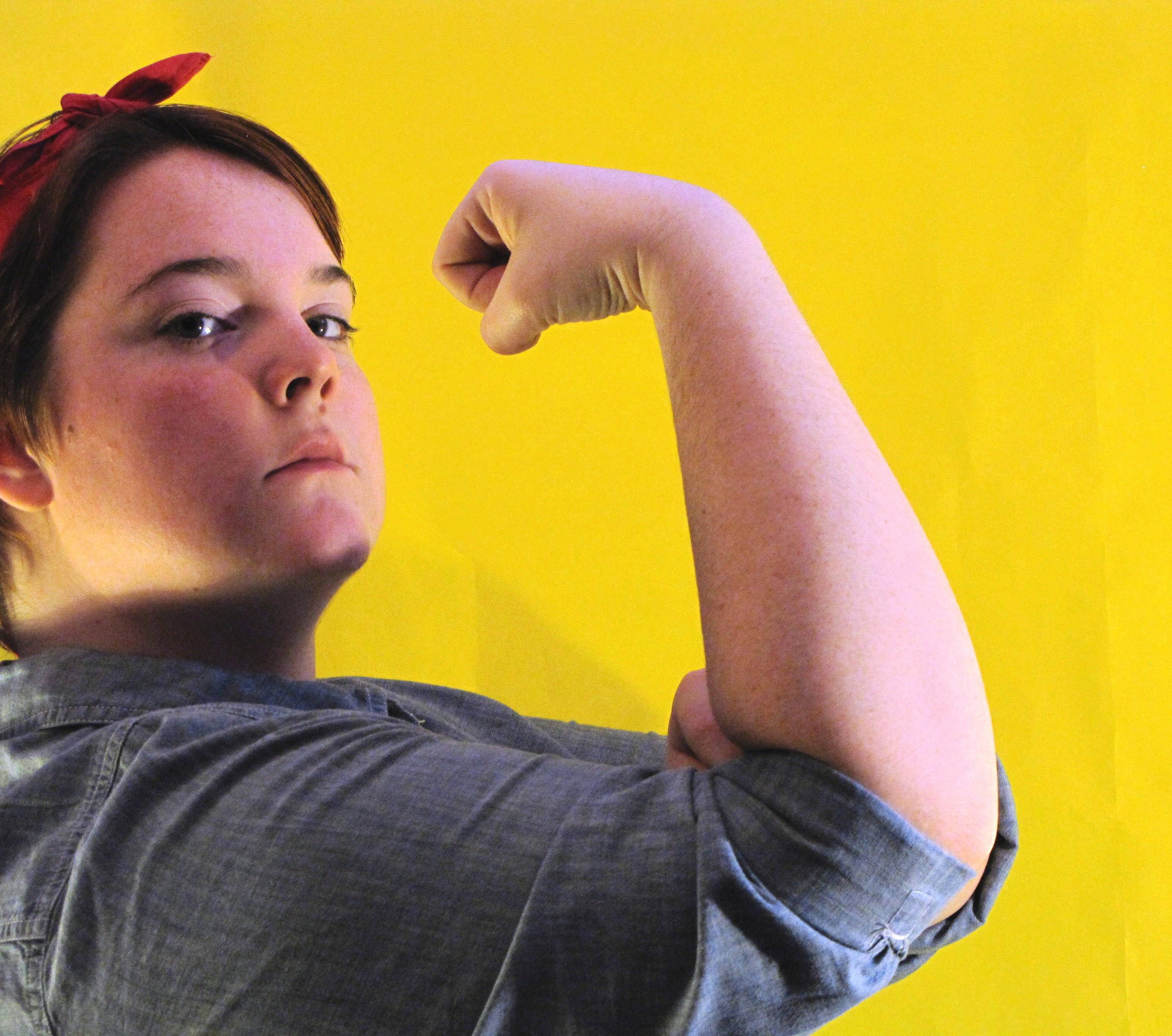 A female student photographed as Rosie the Riveter