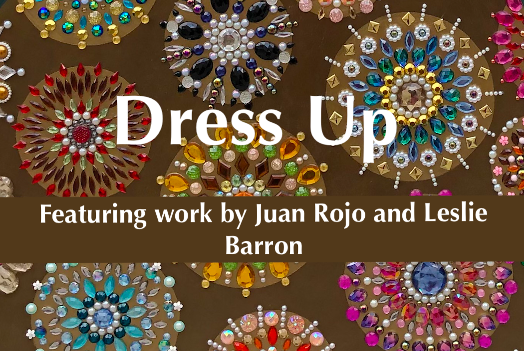 a title card for an exhibition entitled "Dress UP"