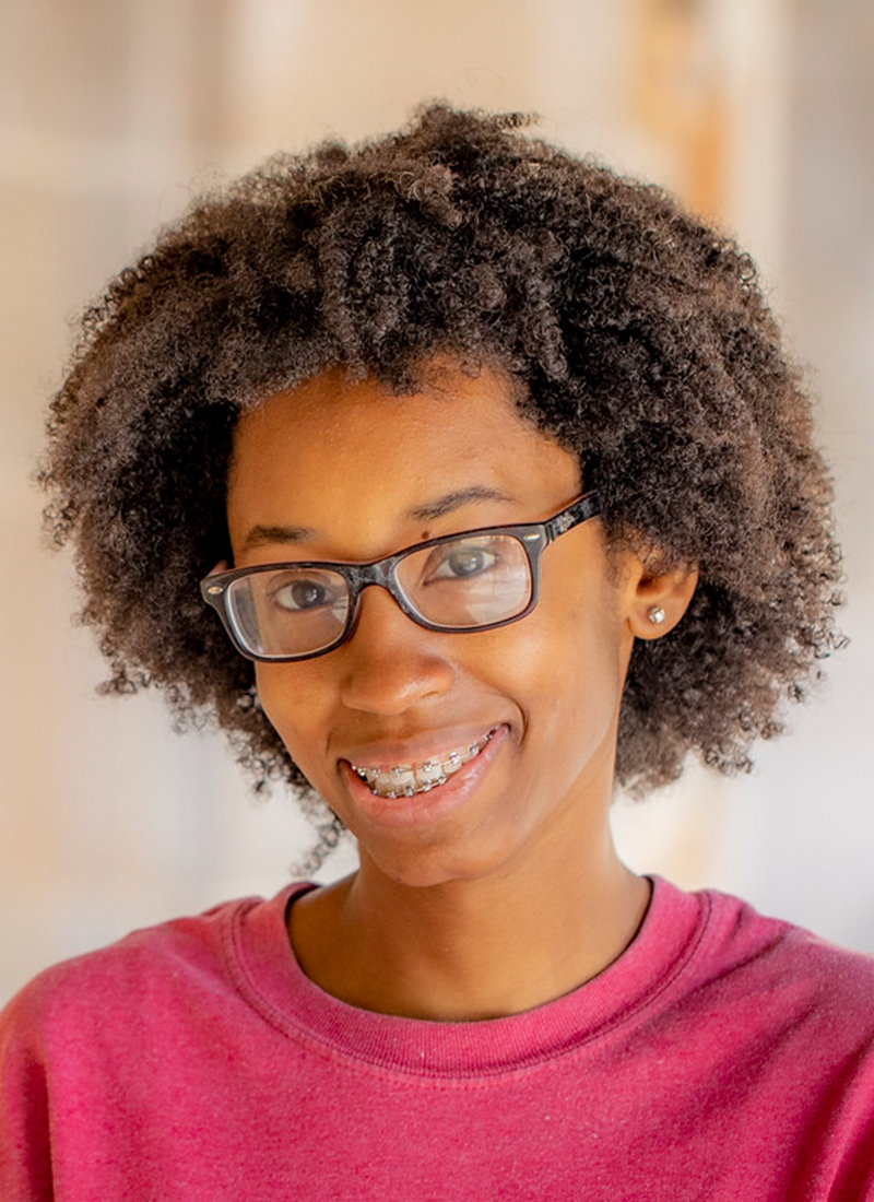 a young African American woman with glasses