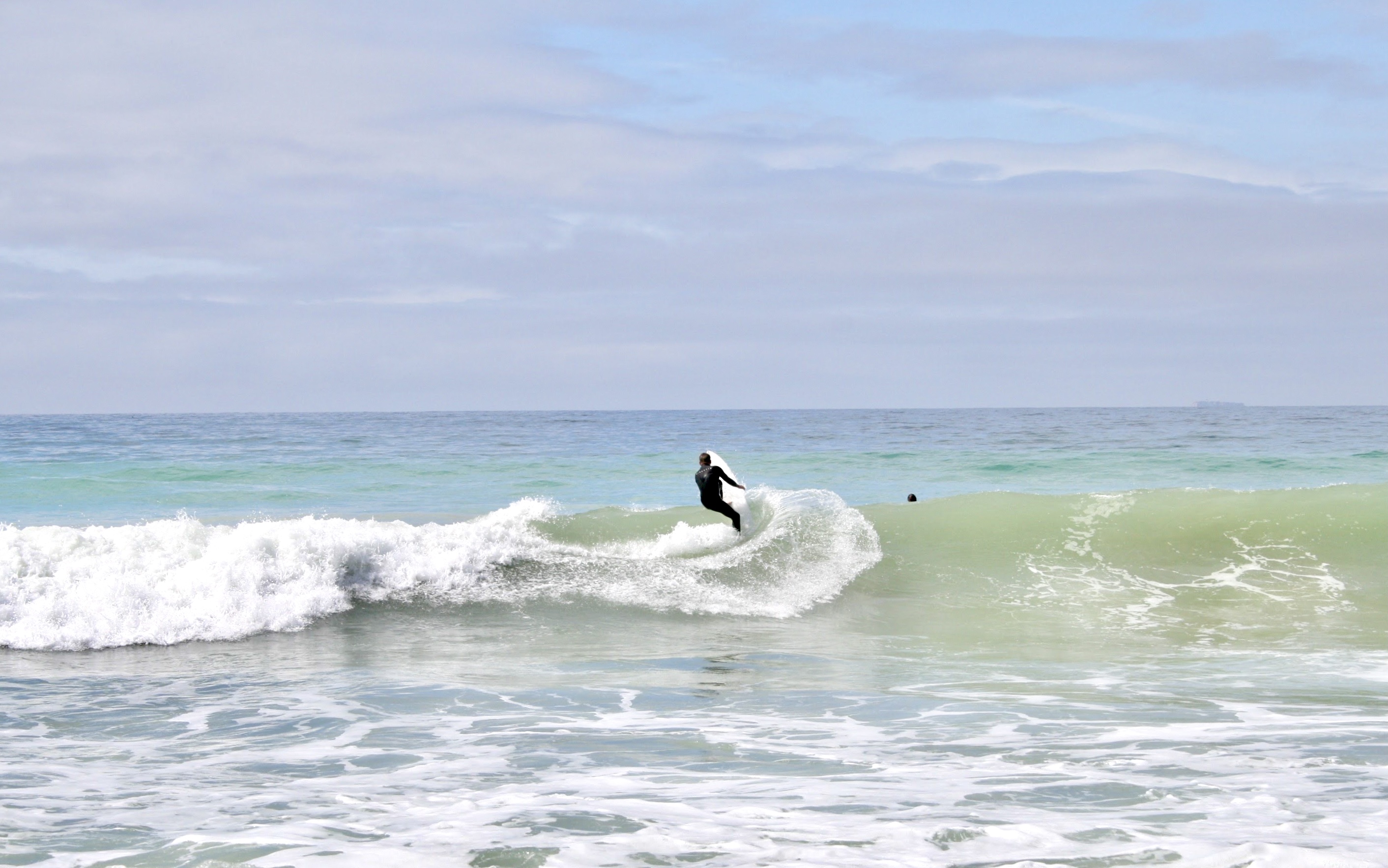 A man surfs a huge wave. 