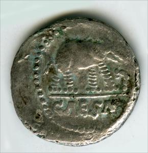 Obverse: Elephant trampling a dragon, on top of CAESAR, encircled in a circle of dots. 