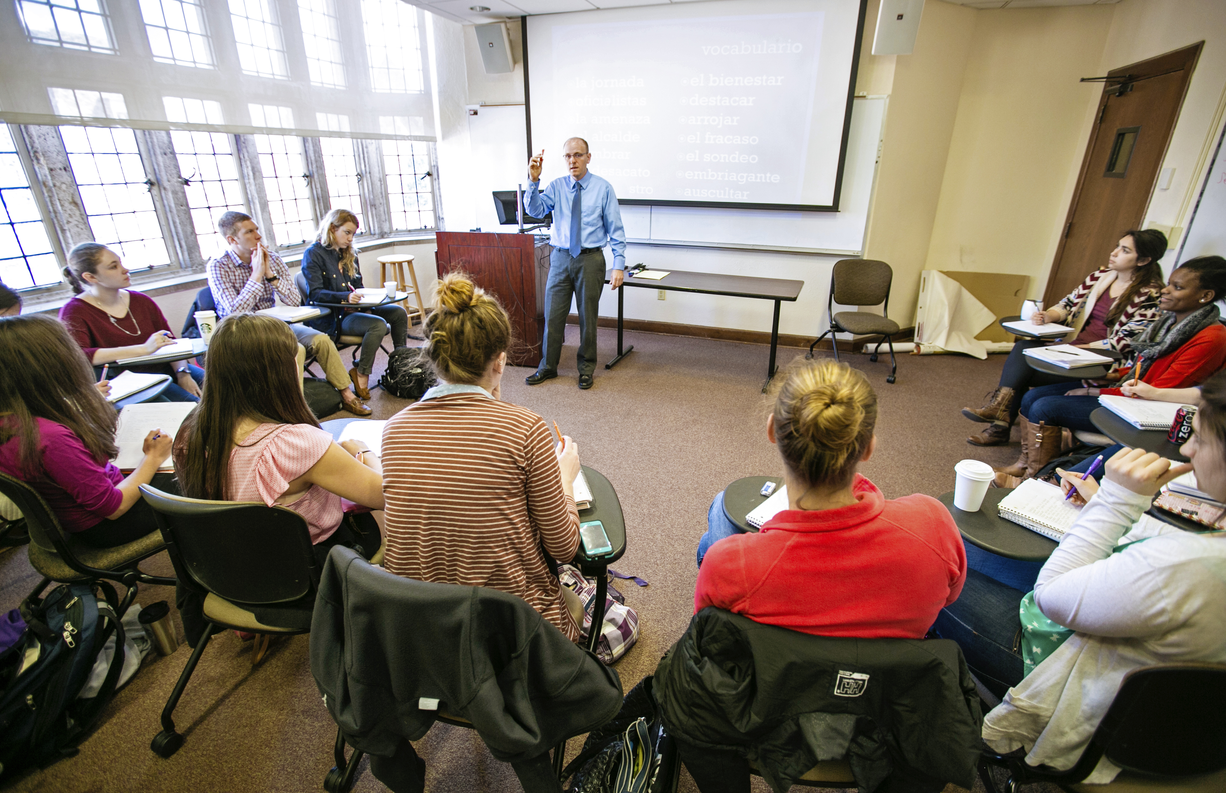 A professor lectures to class of students