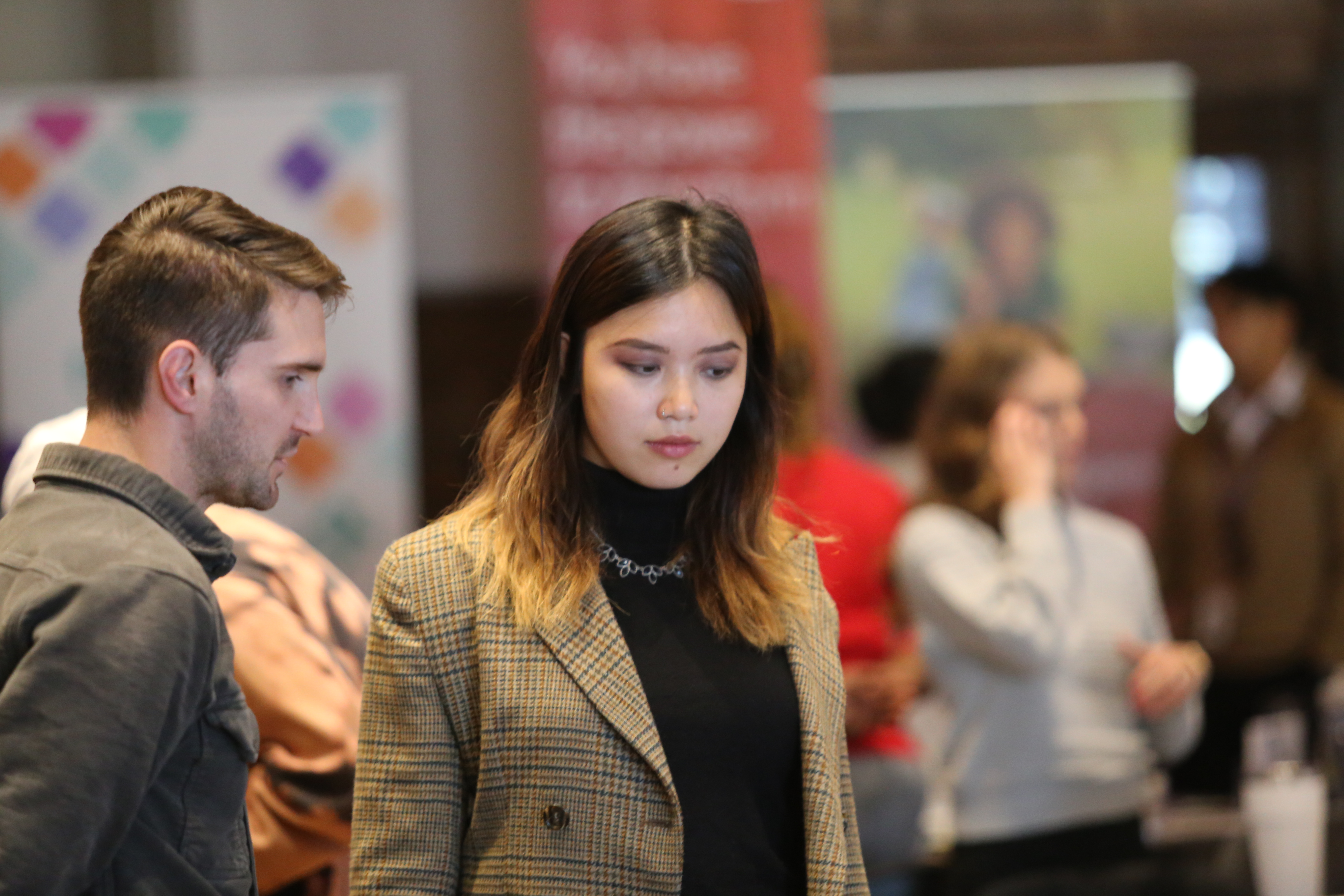 Female student listens to employer at career fair