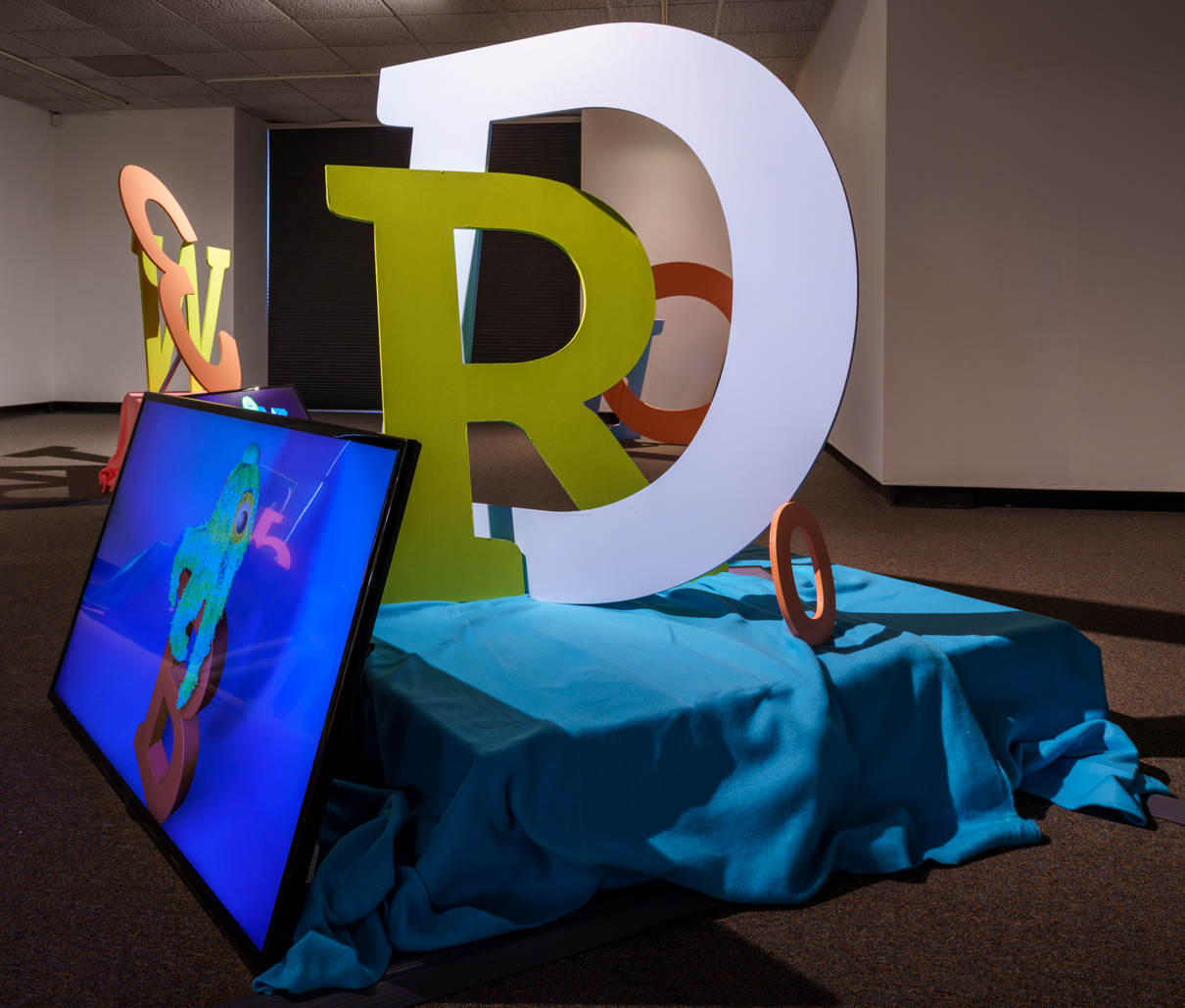 a large installation featuring letters and tv screens