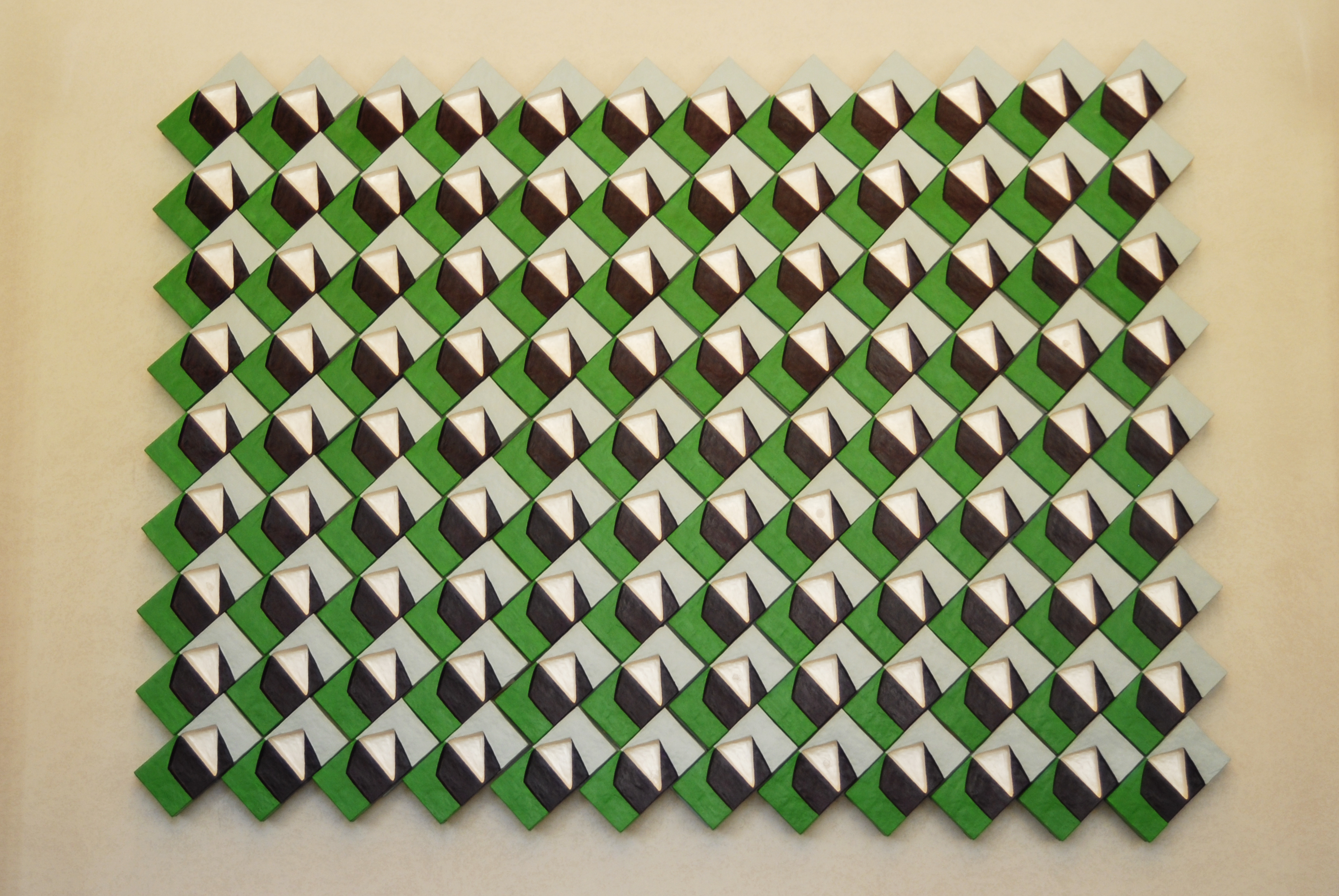 Green, navy, and light blue geometric tiles form a tessellation. 