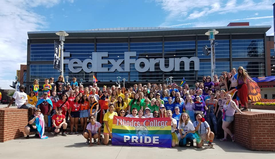 a large group of students, faculty and staff gather at the Pride Parade