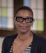 African American woman with short hair and glasses