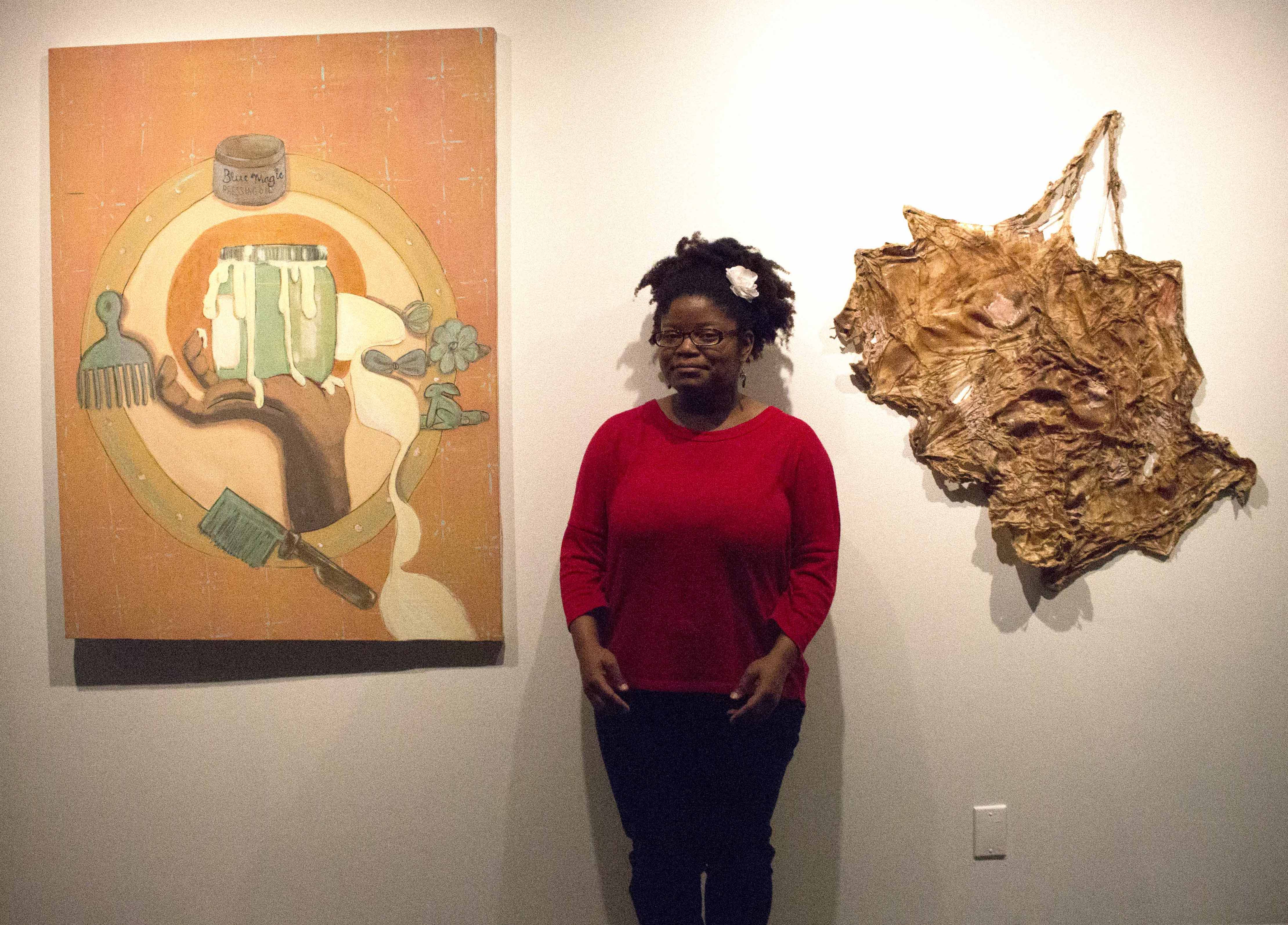 Image of Taylor Jackson standing with her work in Clough-Hanson Gallery.