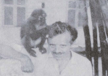 Man with a monkey on his shoulder. 