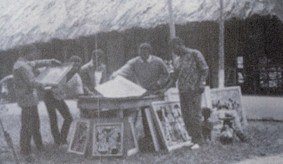 Group of men painting outside.