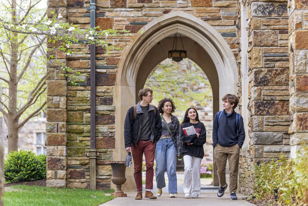 a group of student walk on a Gothic campus