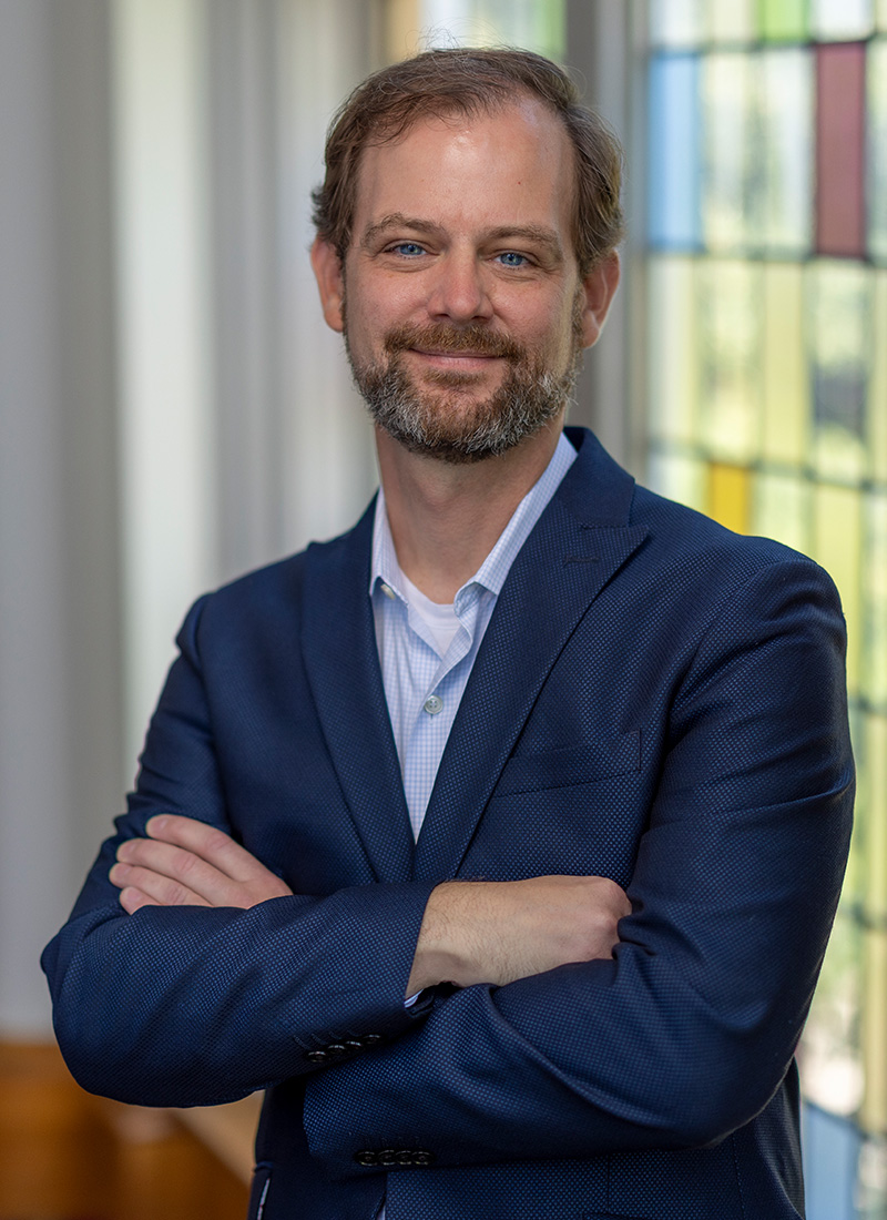 a man with a beard wearing a suit jacket 