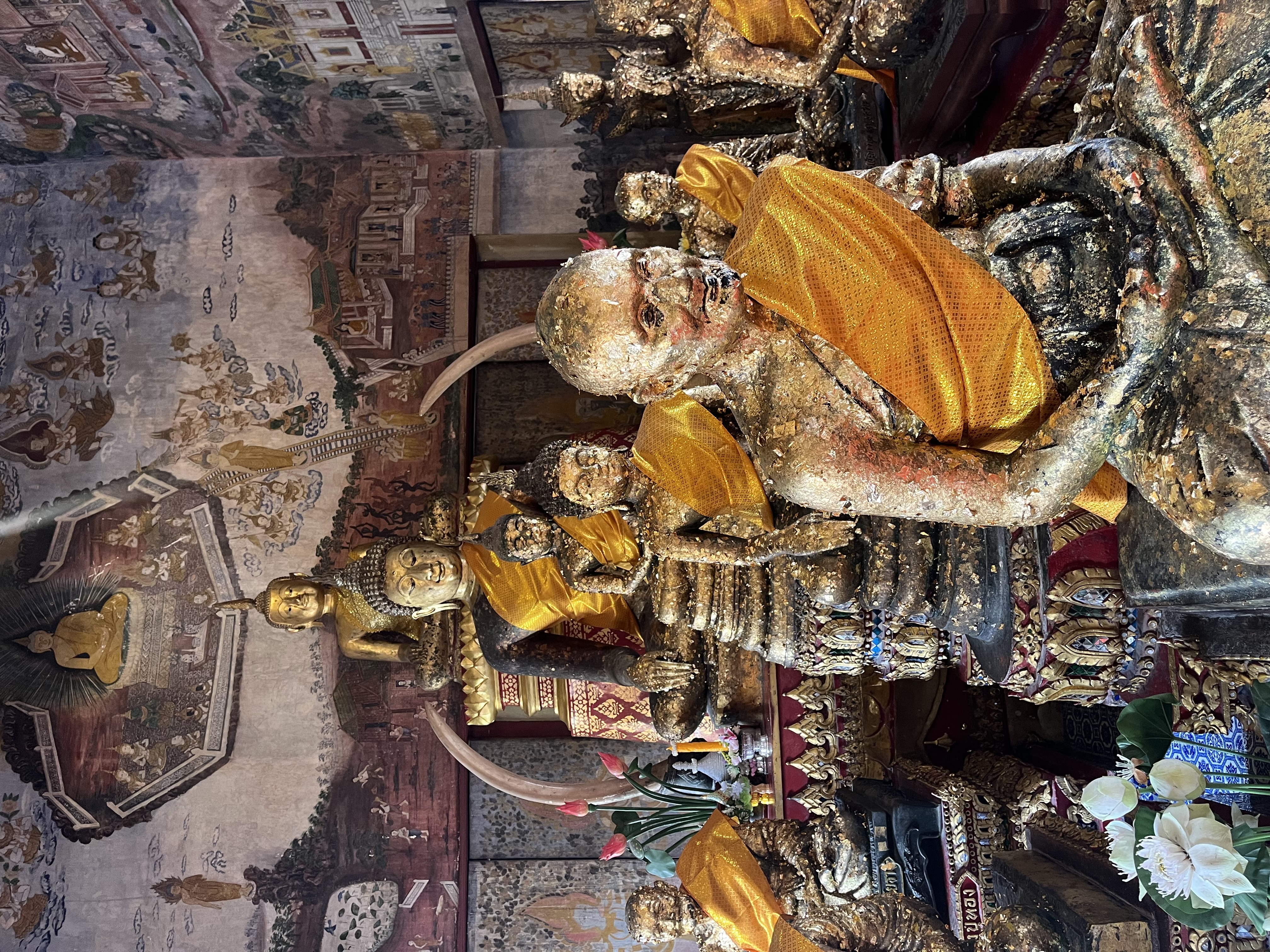 gold-leafed statues of monks and the Buddha