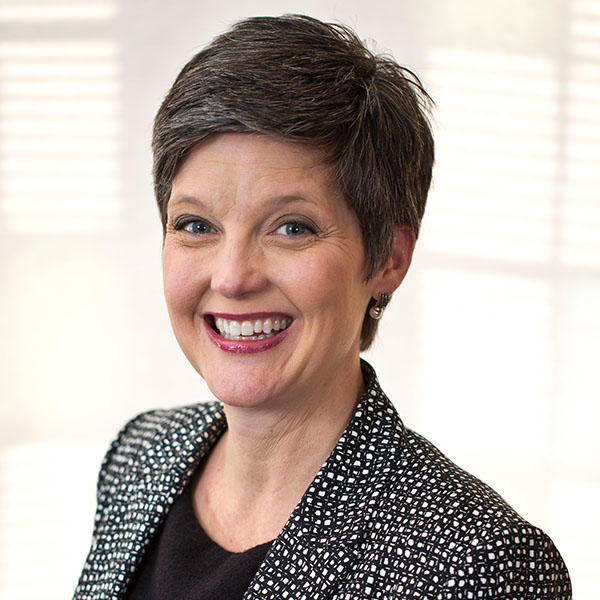a woman with short salt and pepper hair
