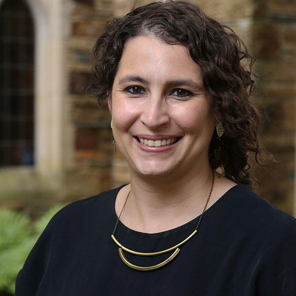 a woman with dark curly hair