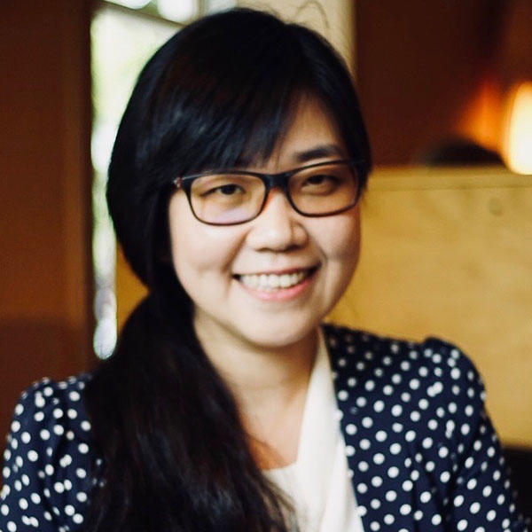 an Asian woman with long hair and glasses