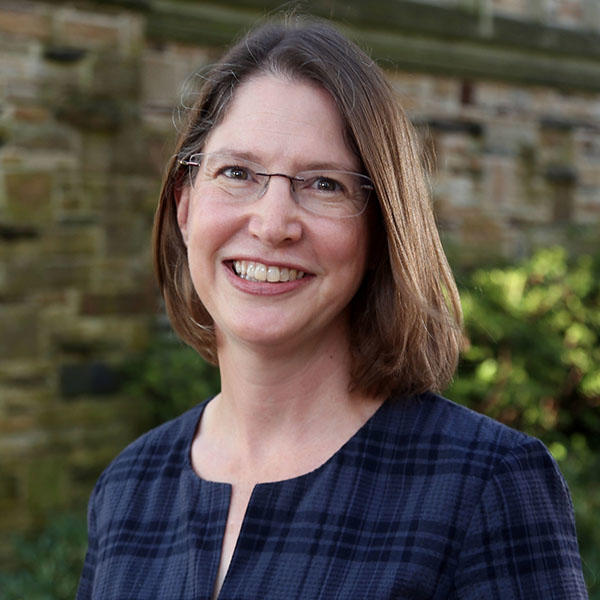 a woman with short brown hair and glasses