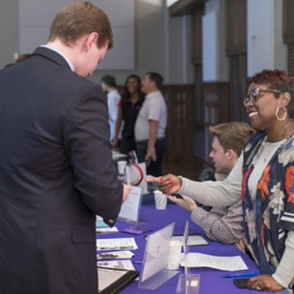 student talking to an employer