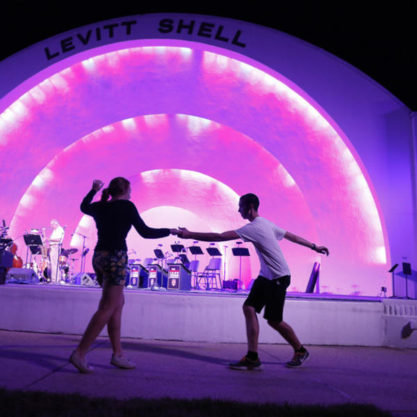 students dance in front of a stage