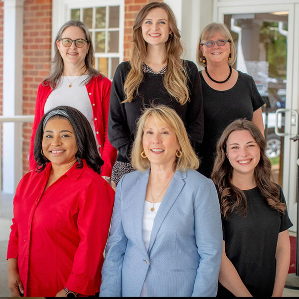 a group of women smile at the camera