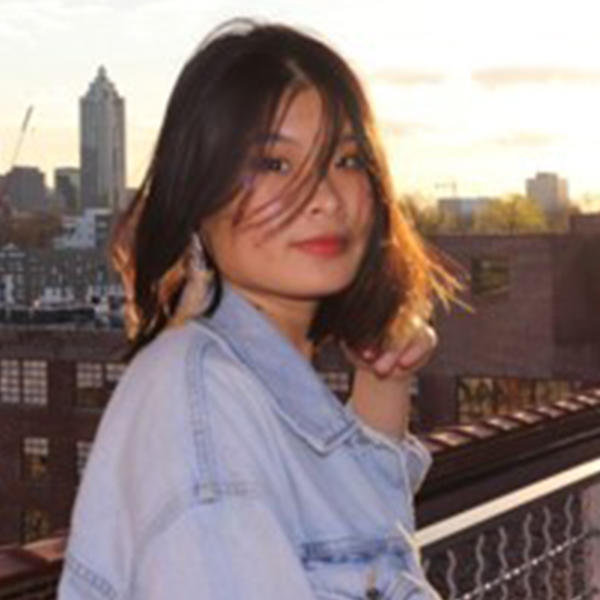 a young Vietnamese woman against a city skyline