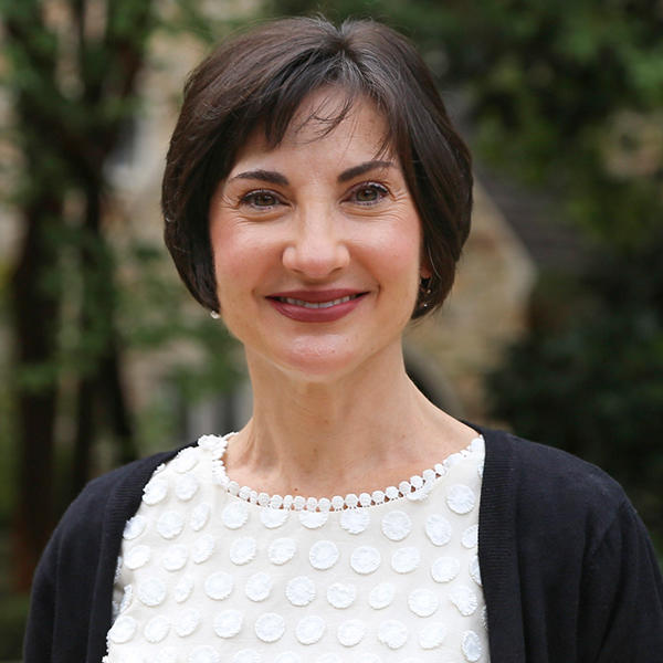 a woman with short dark hair smiles at the camera