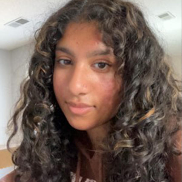 a young woman of Indian heritage with long wavy hair