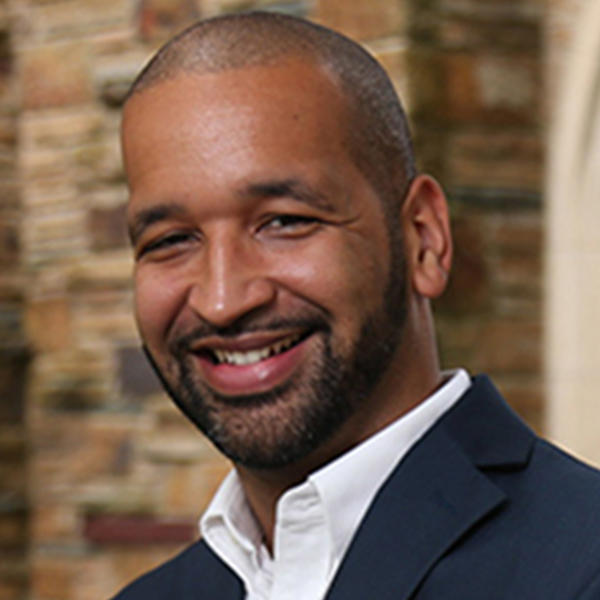 a younger African American man in a blue jacket