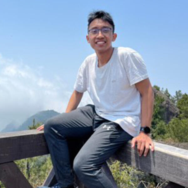 a young man smiles at the camera