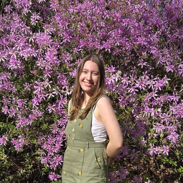 a young woman stands in front of purple flowers, Lauren Bottom| Washington, DC|'27