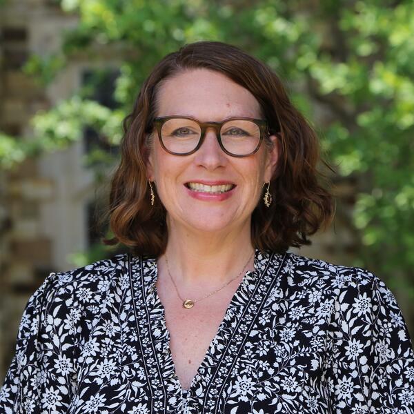 woman with glasses in black and white dress