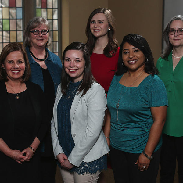 a group of women smile at the camera